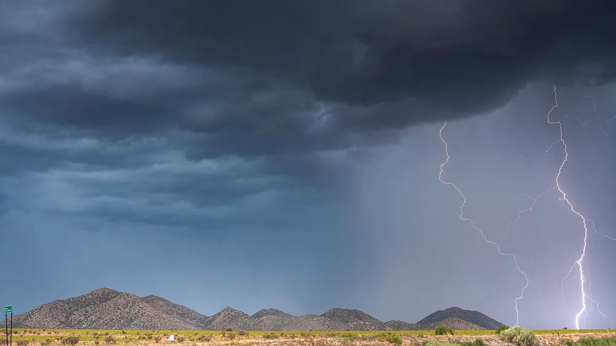 Thunderstorm above an arid southwest landscape.