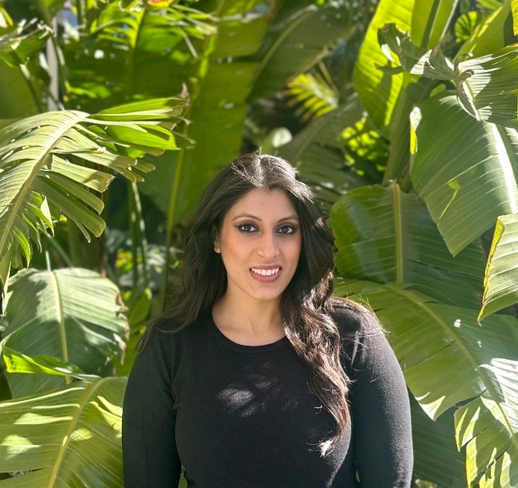 Sabina Malik with green plants in the background.