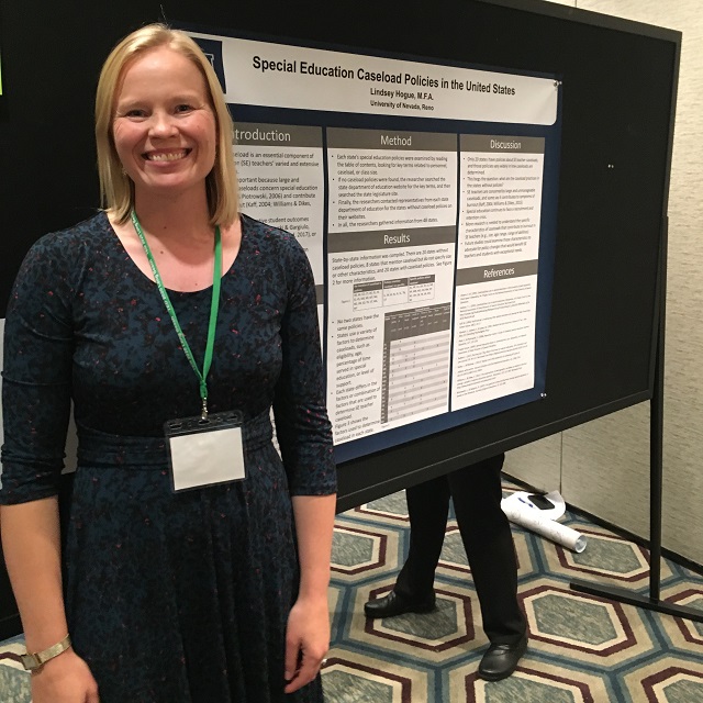 Lindsey Hogue standing next to presentation poster of her research