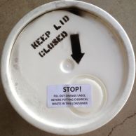 Bucket lid with a label reading 'keep lid closed'