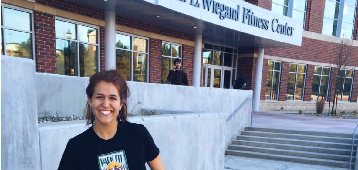 Claire Santamaria in front of the E.L. Wiegand Fitness Center