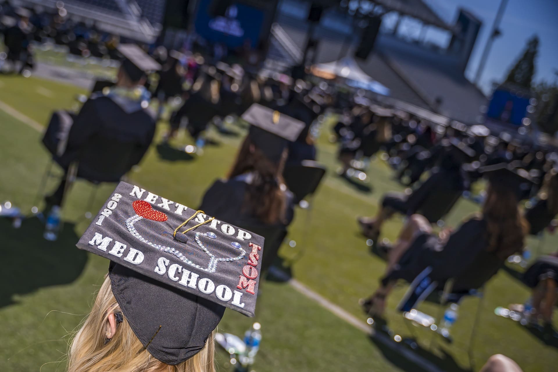 Graduates on the field during commencement at Mackay Stadium