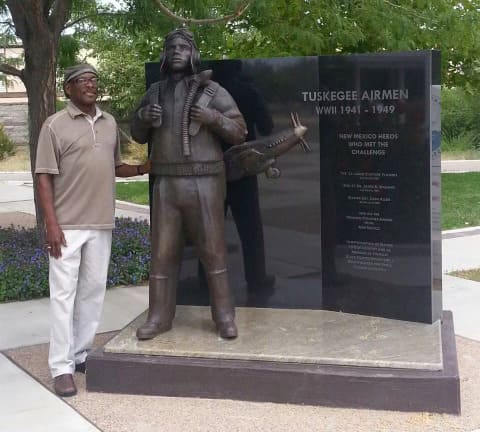 Ben Hazard with his statue honoring Tuskegee airmen