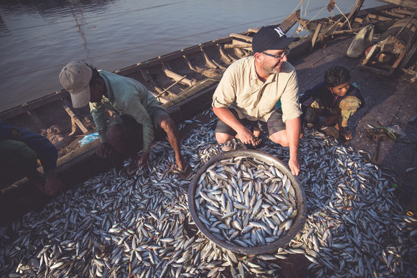 Hogan (middle right) helps sort the fish which often end up sold at local fish markets.
