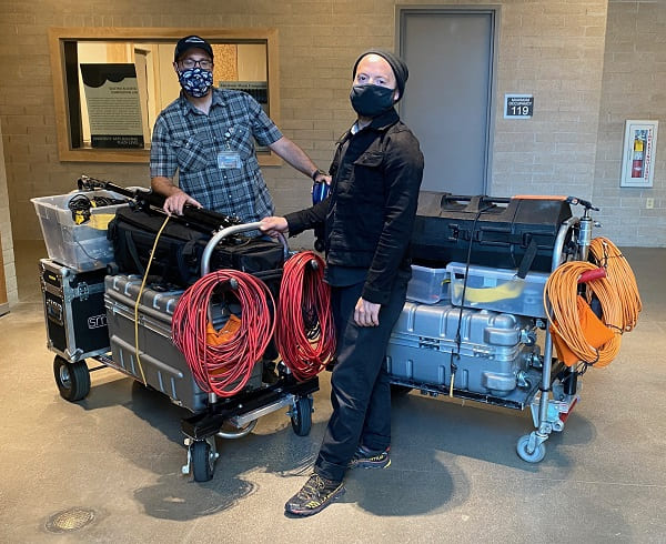 Students posing with camera equipment carts