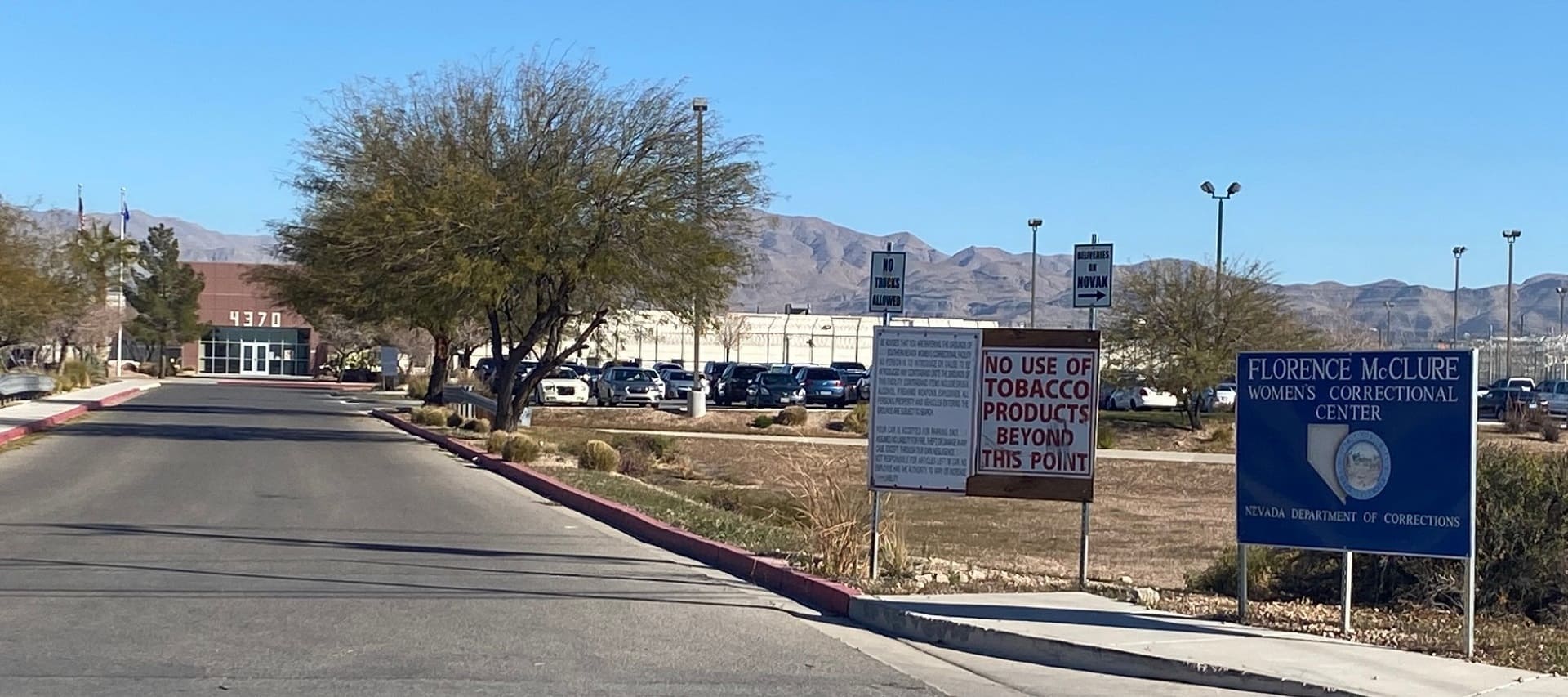 Road to Florence McClure Women’s Correctional Center. A sign reads "No use of tobacco products beyond this point."