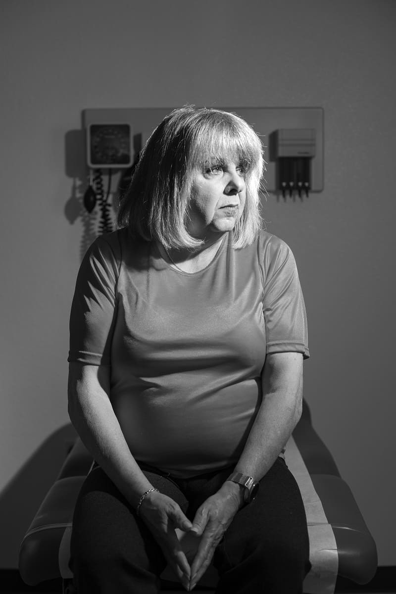  Sherrie Scaffidi at the clinic helping train medical students, sitting on an examination table