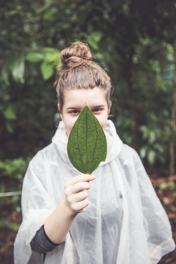 Ava Dieden holds a leaf in front of her face