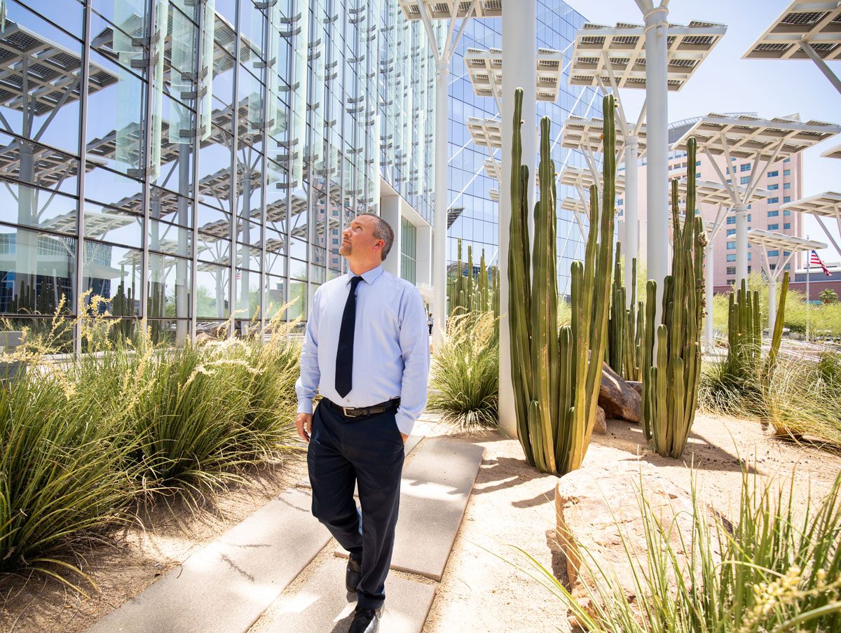 Marco Velotta walks beneath solar panels at City Hall