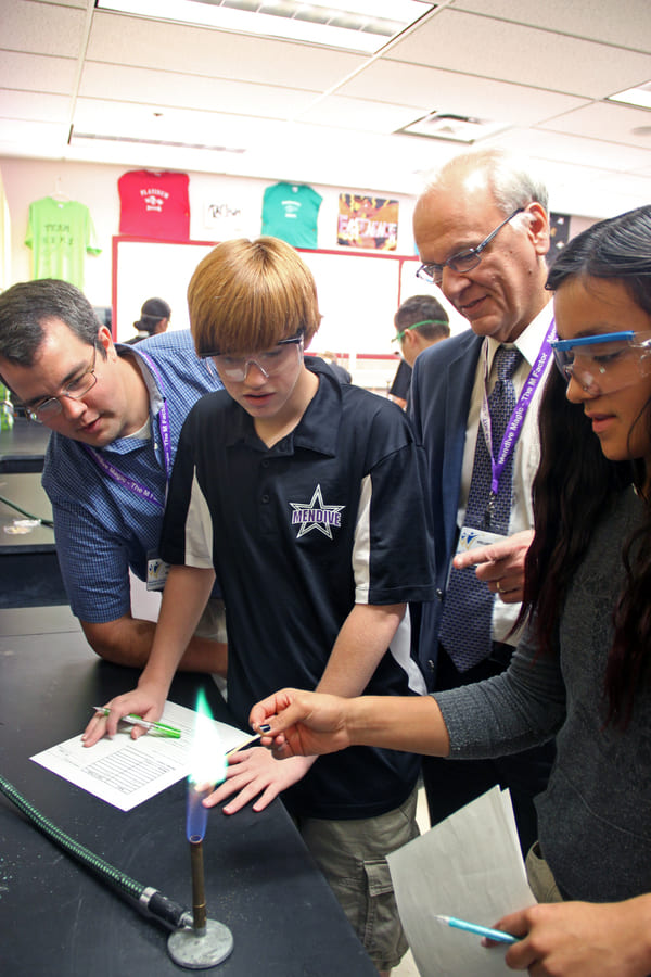 Manos visiting with high school students in a STEM class