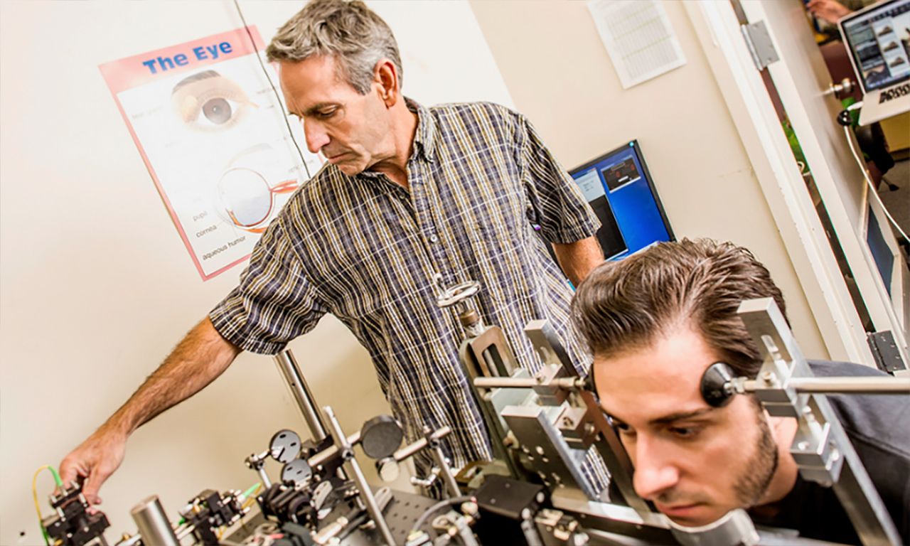 Mike Crognale in lab with student conducting a neurological experiment