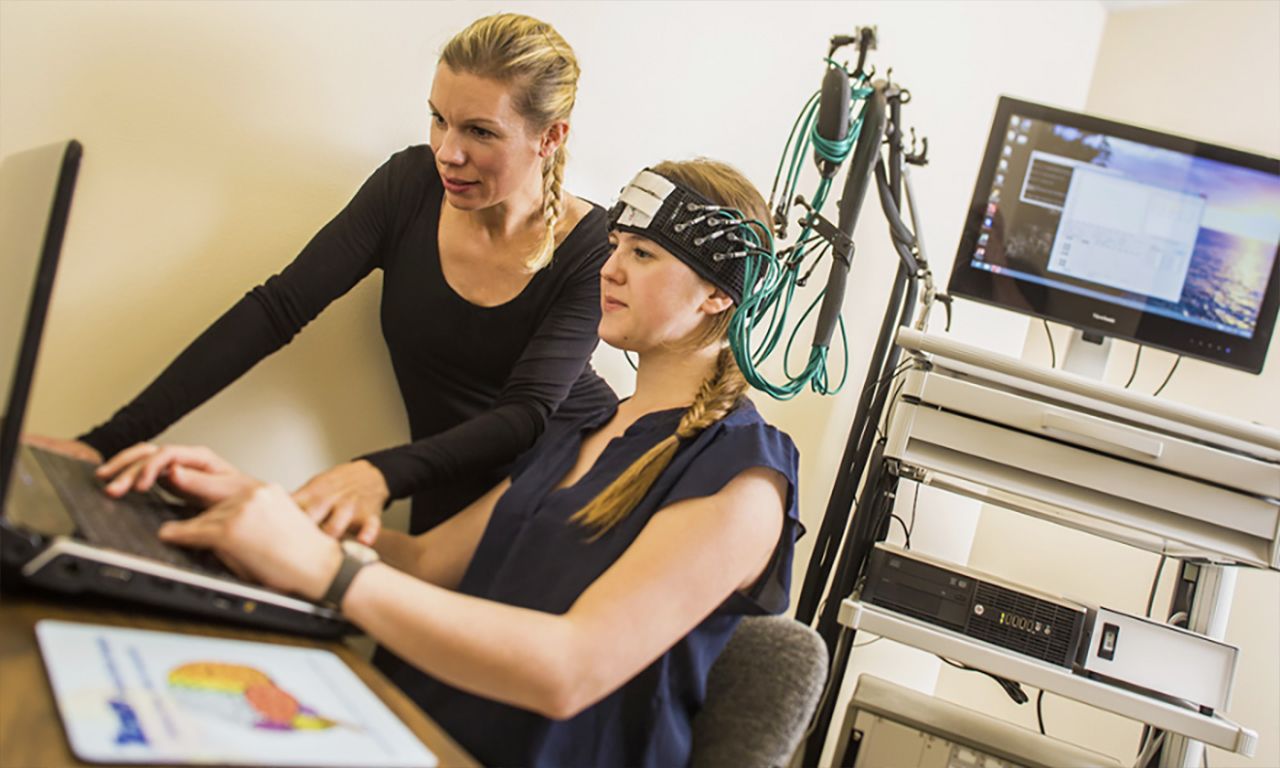 Jacqueline Snow with student conducting brain neurology test in office