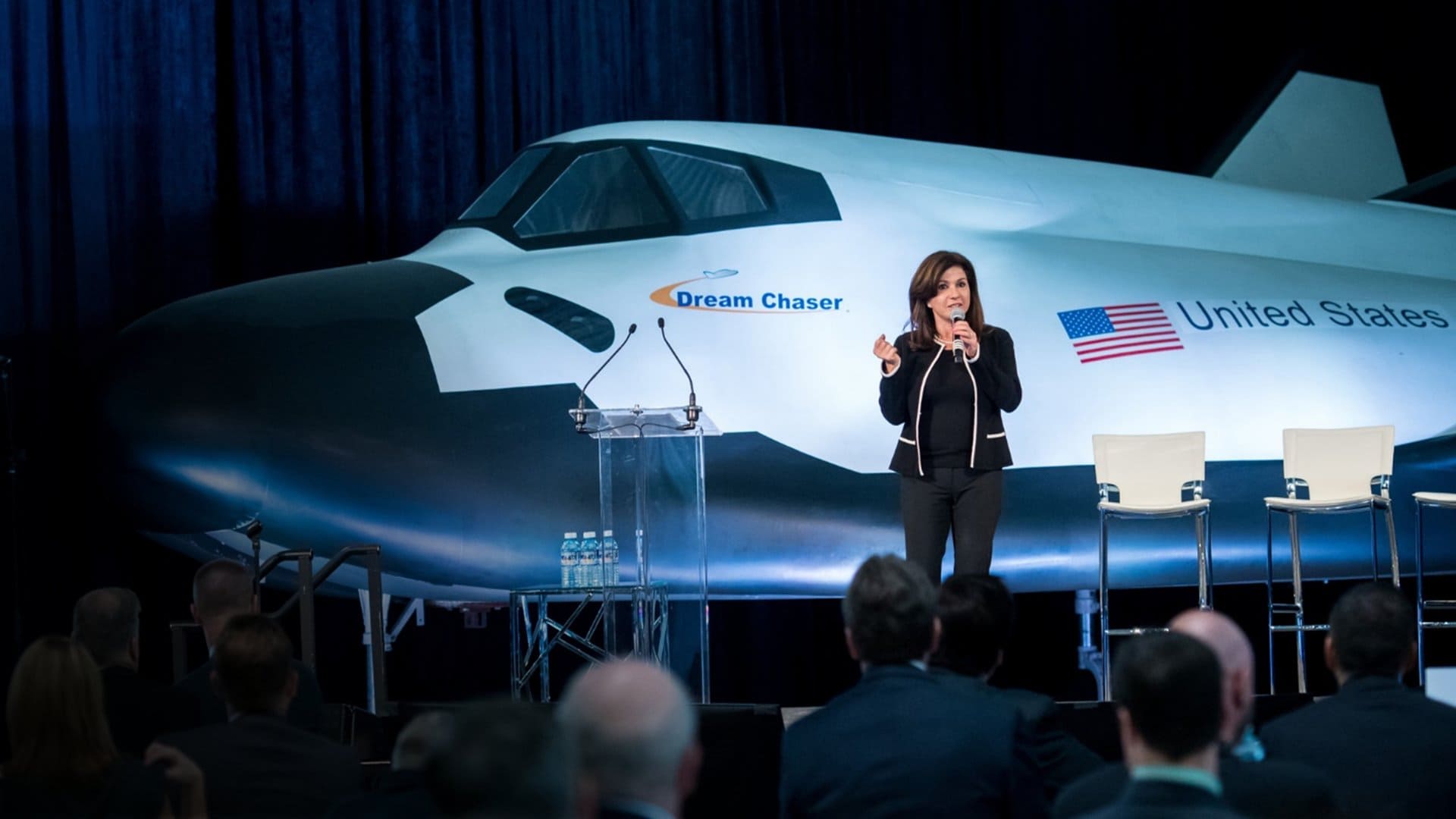 Eren Ozmen standing in front of the Dream Chaser spacecraft