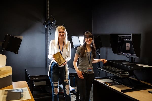 Digital Services student assistants Taylor Kunze and Marisa Kuhlman working in the Digital Services Lab.