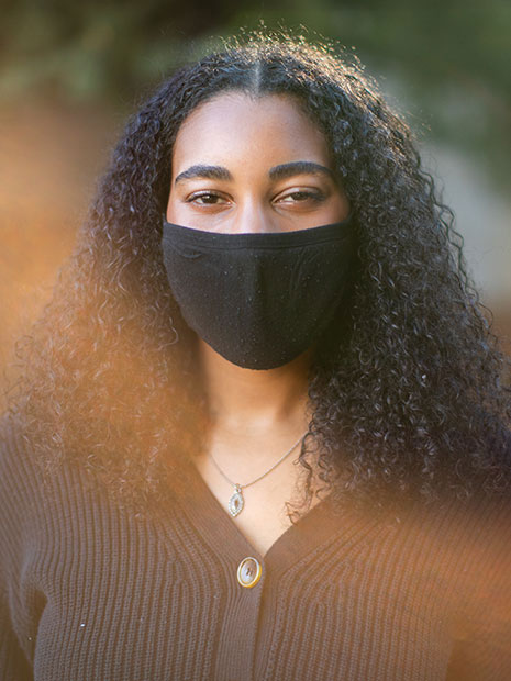 POrtrait of Lizzy Hairston wearing a face covering