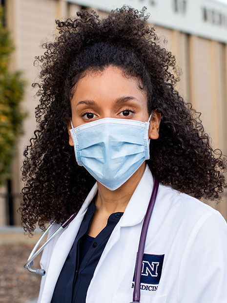 POrtrait of tasha Vazquez wearing a medical mask and a stethescope.