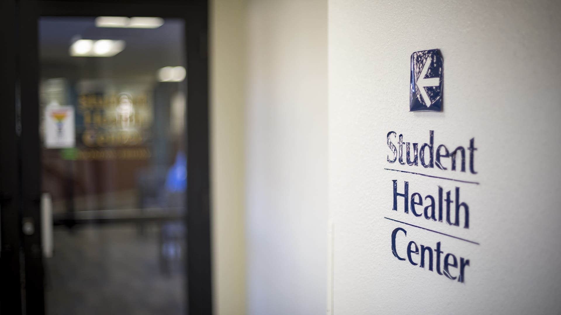 The words "Student Health Center" are on the right wall of a hallway with the entrance door on the left