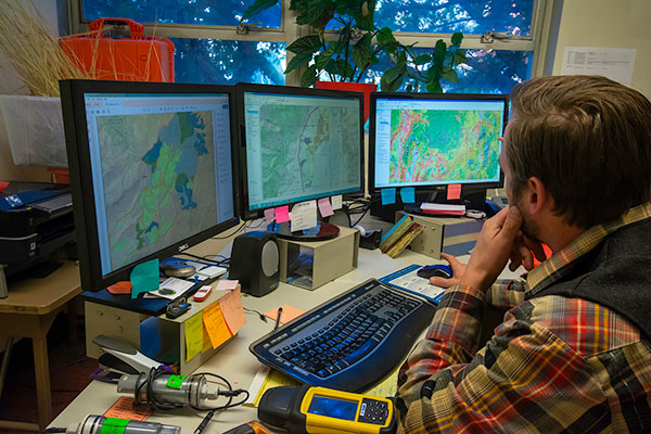 A lab researcher maps information about a range.