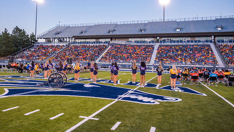 Cheerleaders on the football field during Opening Ceremony.