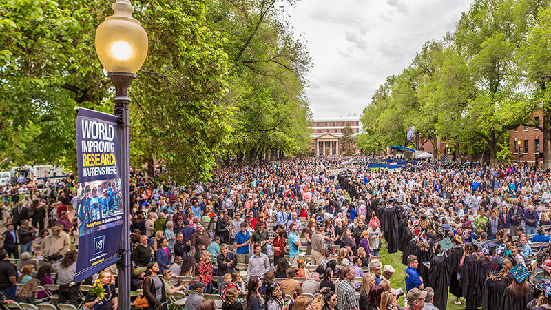 Graduates and their families on the Quad for graduation