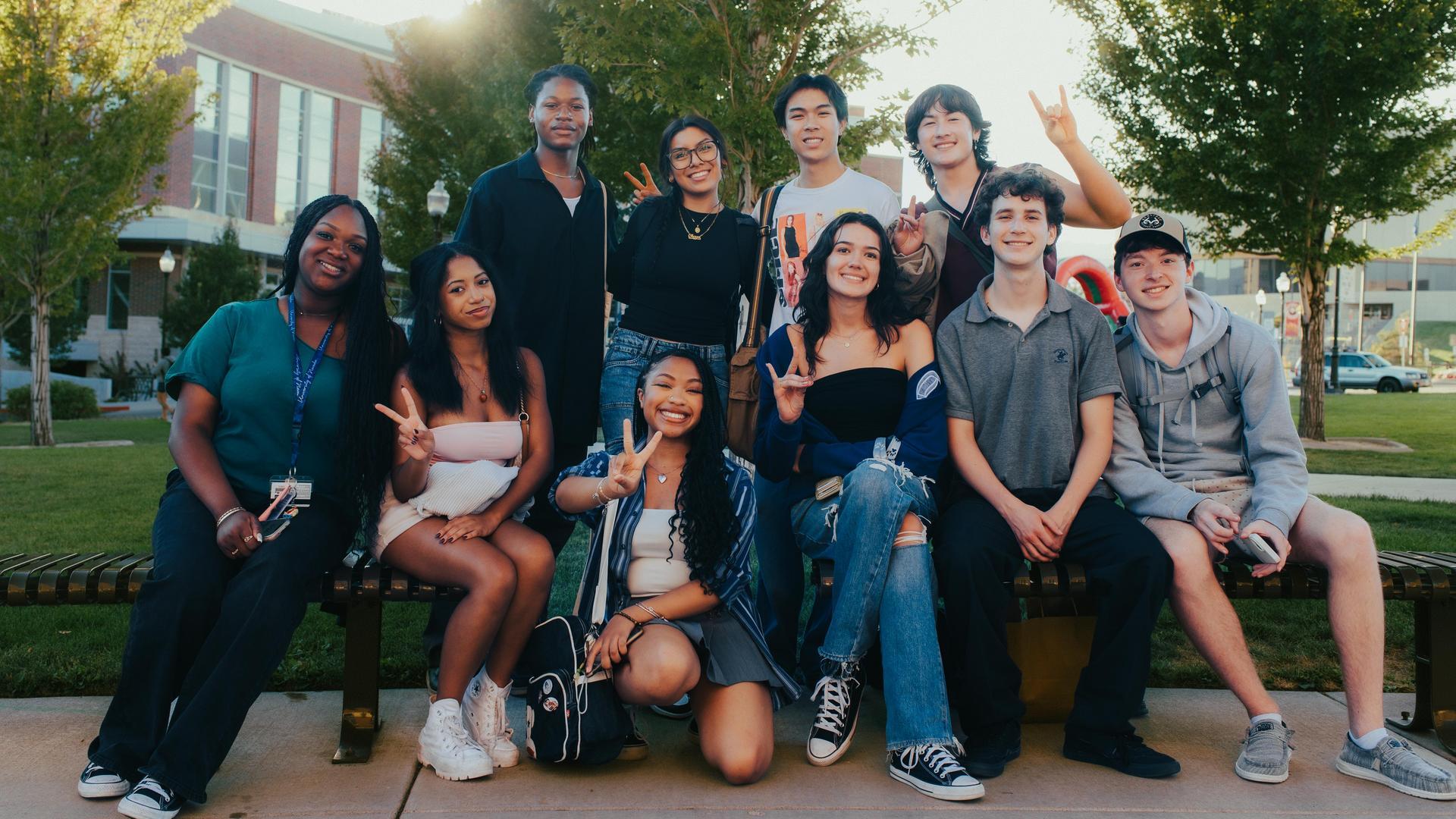 A group of students giving peace signs on the University of Nevada, Reno campus.