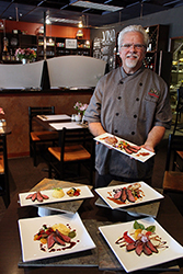 Man presents food in restaurant.