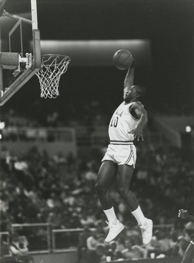 Boris King in mid air about to dunk a basketball