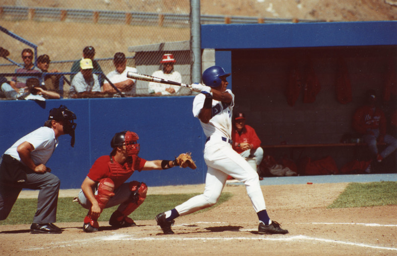 Chris Singleton follows through on a swing at home plate on the baseball diamond