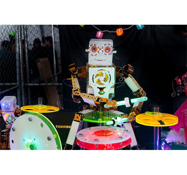 A Robot plays the drums at a Maker Faire