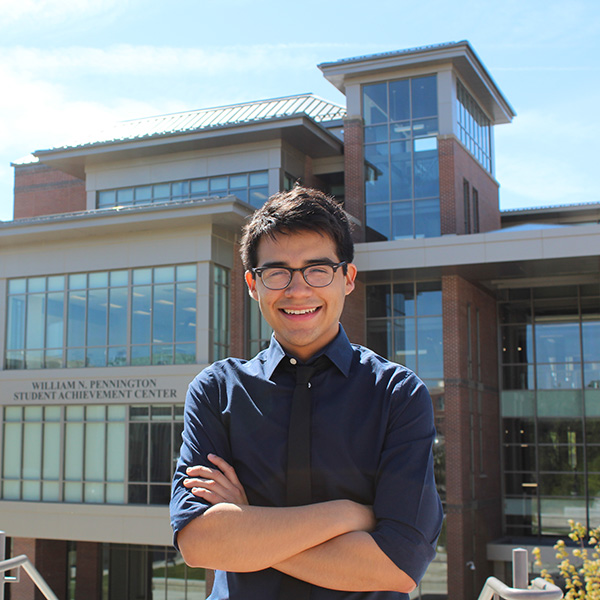 Josue Regalado in front of the Pennington Student Achievement Center