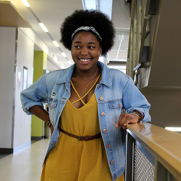 Nicole Claiborne stands in a hallway