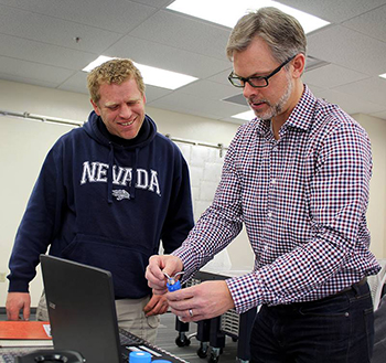 Craig Vincze works on his 3D printed lab ware.