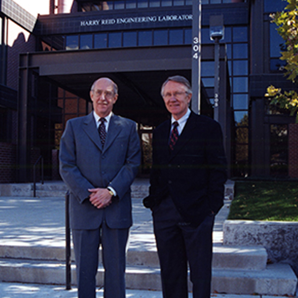 Joe Crowley and Sen. Harry Reid posing in front of the Harry Reid Engineering Laboratory