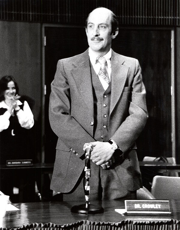 Joe Crowley posing at his desk after being elected University president