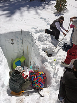 Students dig snow pit for science