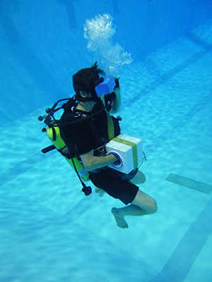 Paul MacNeilage scuba diving in pool with VR headset