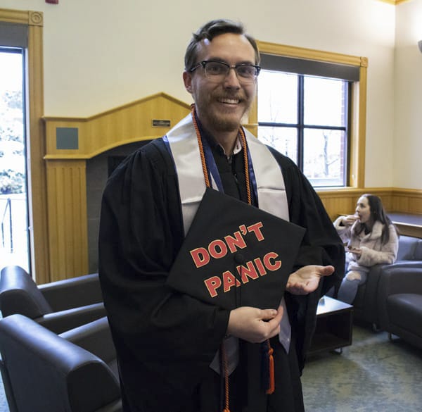 Student poses with grad cap.