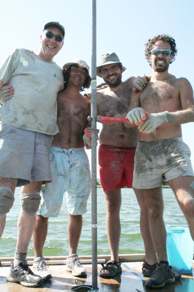 Four men coring a lake