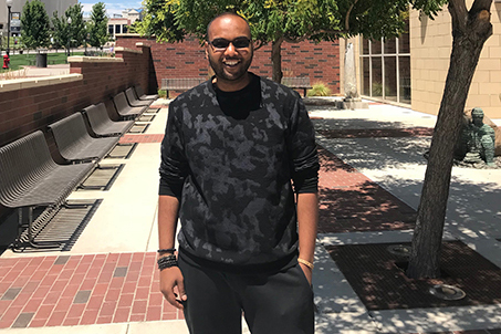 Elbashier poses in front of a tree near the Knowledge Center.