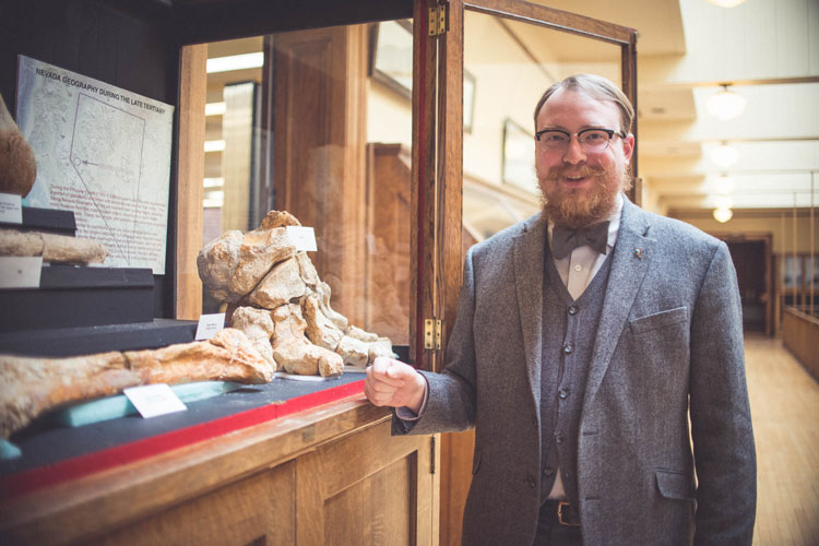 Garrett stands near the mastodon display