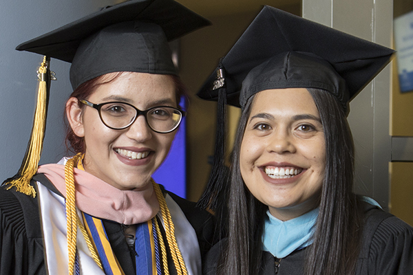 Smiling graduates at the Asian American & Pacific Islander Graduate Celebration