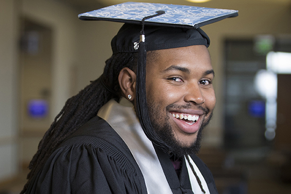 A smiling graduate at the African Diaspora Graduate Celebration