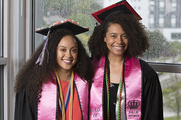 Two graduates smiling at the African Diaspora Graduate Celebration