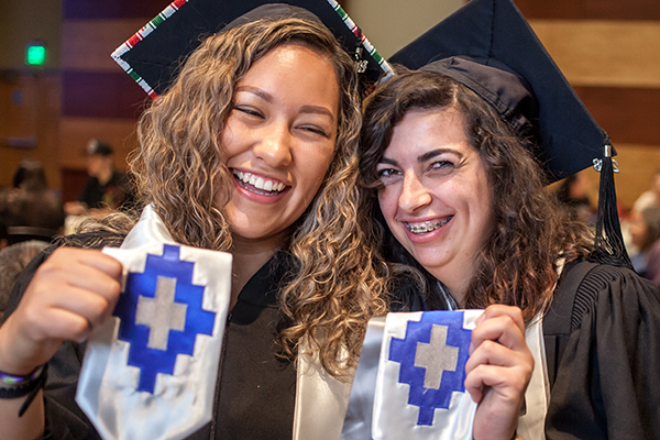 Two happy graduates at the American Indian & Alaskan Native Graduate Celebration