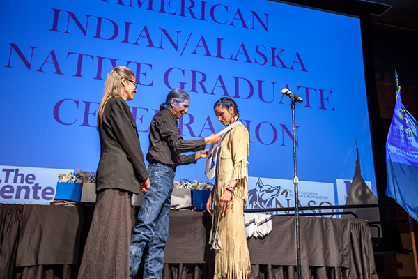 A graduate being honored at the American Indian & Alaskan Native Graduate Celebration