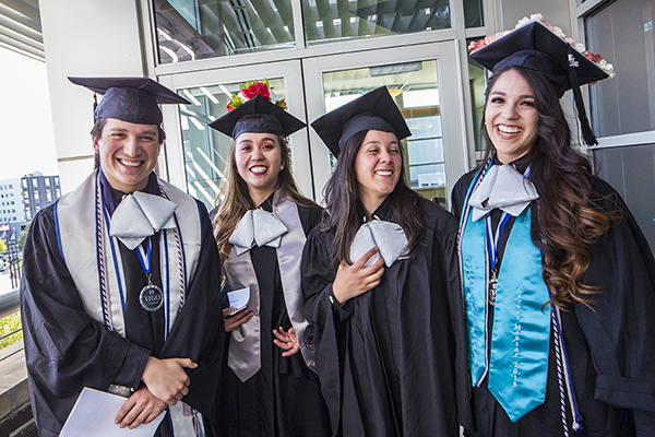 Four graduates outside the Latinx Graduate Celebration