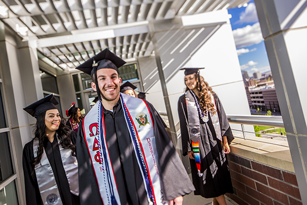 Graduates with a variety of honors around their necks outside the Latinx Graduate Celebration