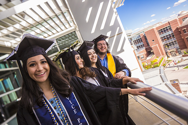 Graduates looking over the balcony outside the Latinx Graduate Celebration