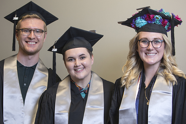 Smiling graduates at the Lavender Graduate Celebration