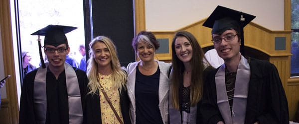 Students and faculty pose indoors.